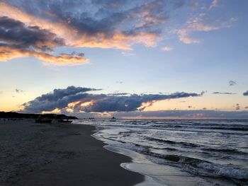 Scenic view of beach against sky during sunset