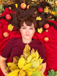 Portrait of cute girl with red flowers