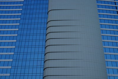 Low angle view of office building against blue sky