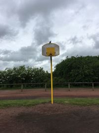 View of basketball hoop on field against sky