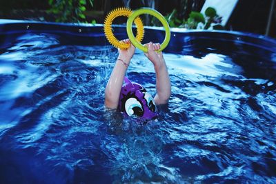 Low section of boy in swimming pool