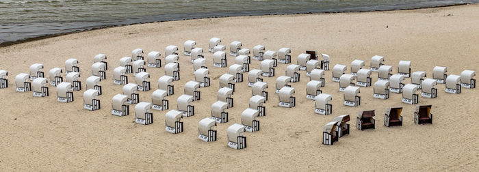 High angle view of hooded chairs at beach