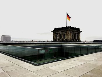 Flag on built structure against sky