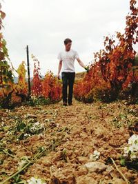 Full length of man standing on field against sky