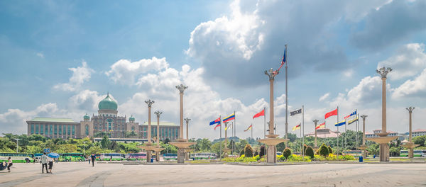 Panoramic view of buildings against cloudy sky