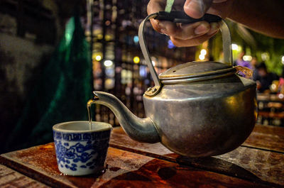 Close-up of hand holding tea cup