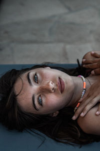 Portrait of young woman lying down