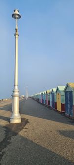 Street light on beach against buildings in city