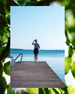 Full length of woman standing by sea against sky