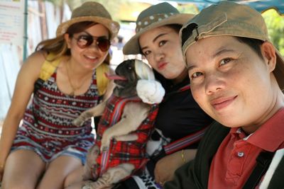 Portrait of smiling friends sitting in vehicle