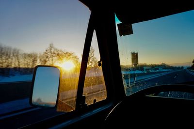 Close-up of car window during sunset