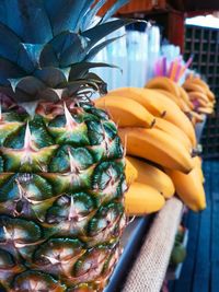 Close-up of bananas and pineapple on counter