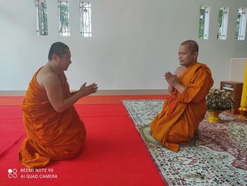 Side view of man sitting in temple