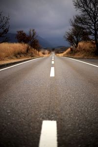 Road amidst field against sky