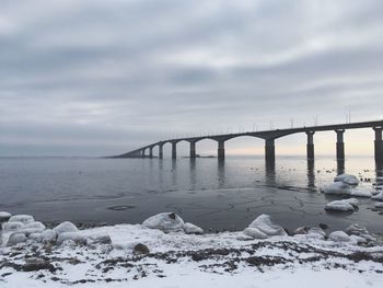 Bridge over river during winter