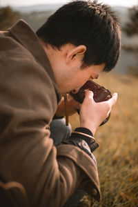 Young man photographing outdoors