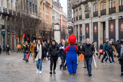 Group of people walking on street in city