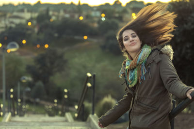 Portrait of smiling young woman standing outdoors