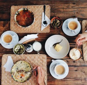 Cropped image of hands having food at table