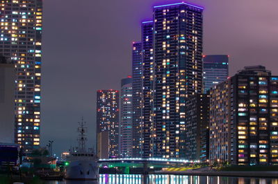 Illuminated buildings against sky at night