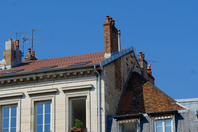 Low angle view of old building against blue sky