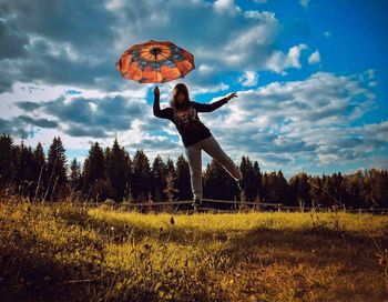 Man standing on field against sky