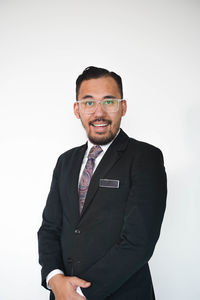 Portrait of smiling mid adult man against white background