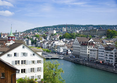 High angle view of river amidst buildings against sky