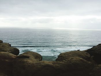 Scenic view of sea against cloudy sky