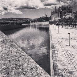 River by cityscape against sky