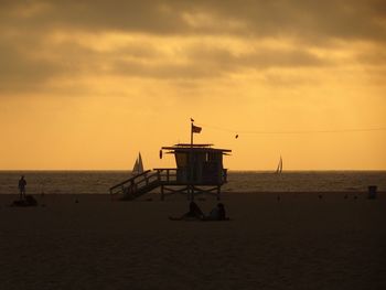 Silhouette ship on sea against sky during sunset