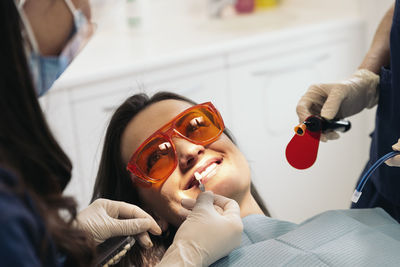 Female dentists operating patient in hospital