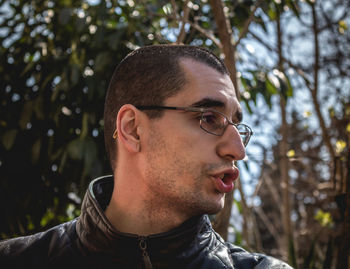 Close-up portrait of young man looking away