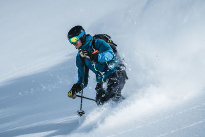 Man enjoying skiing in deep powder snow, gastein, salzburg, austria