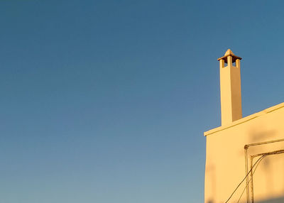 Low angle view of cross against clear sky