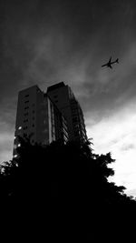 Low angle view of building against cloudy sky