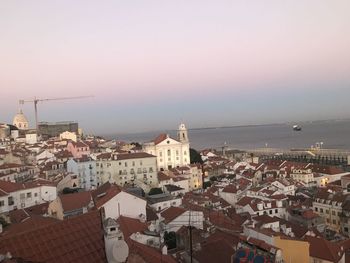 High angle view of townscape by sea against sky