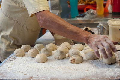 Midsection of man preparing food