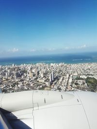 Aerial view of sea and buildings against sky