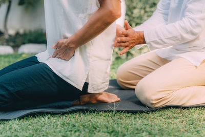 Reiki course instruction. woman sitting , having a reiki healing treatment.