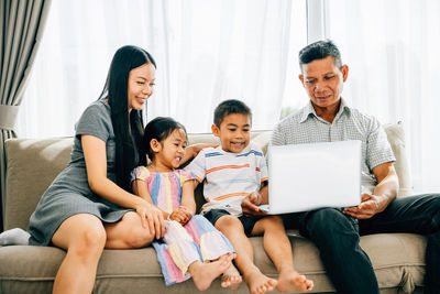 Family using laptop at home