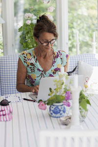 Woman using laptop at home