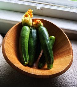 High angle view of zucchini in bowl by window
