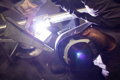 Man welding metal at factory