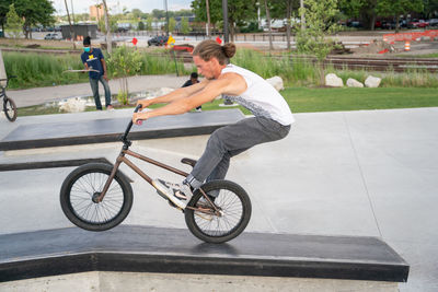 Side view of man riding bicycle