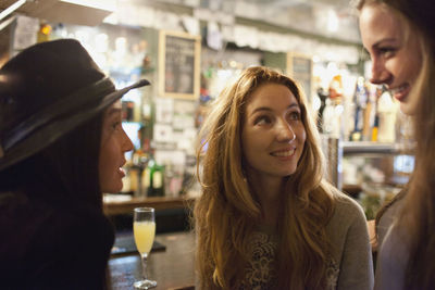 Portrait of smiling young woman in restaurant