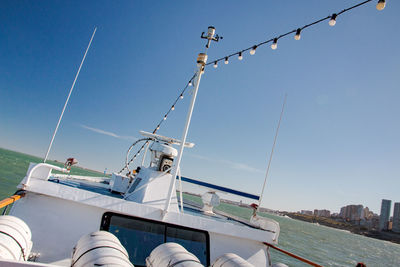 Sailboats moored in sea against clear sky