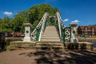 Surface level of staircase against blue sky in park