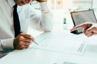 Midsection of man working on table