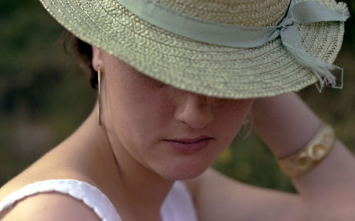 Close-up portrait of woman wearing hat